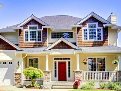 Exterior of a beautiful home painted in cream color with a striking red door