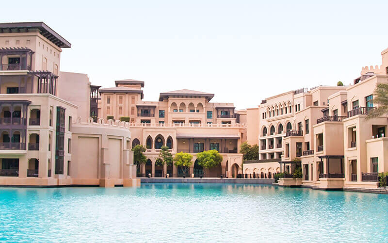 Luxurious buildings around a serene, crystal-clear pool