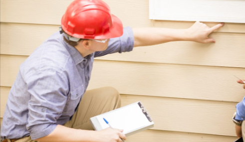 Trusted home inspectors in San Antonio inspecting exterior siding – A.I.M. For Real Estate Inspections TREC 5171