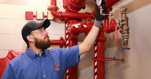 A.I.M. For a Real Estate Inspections technician performing a sprinkler inspection on commercial fire sprinkler system equipment