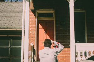 Home inspectors in San Antonio reviewing the exterior of a suburban house during a pre-purchase home inspection.